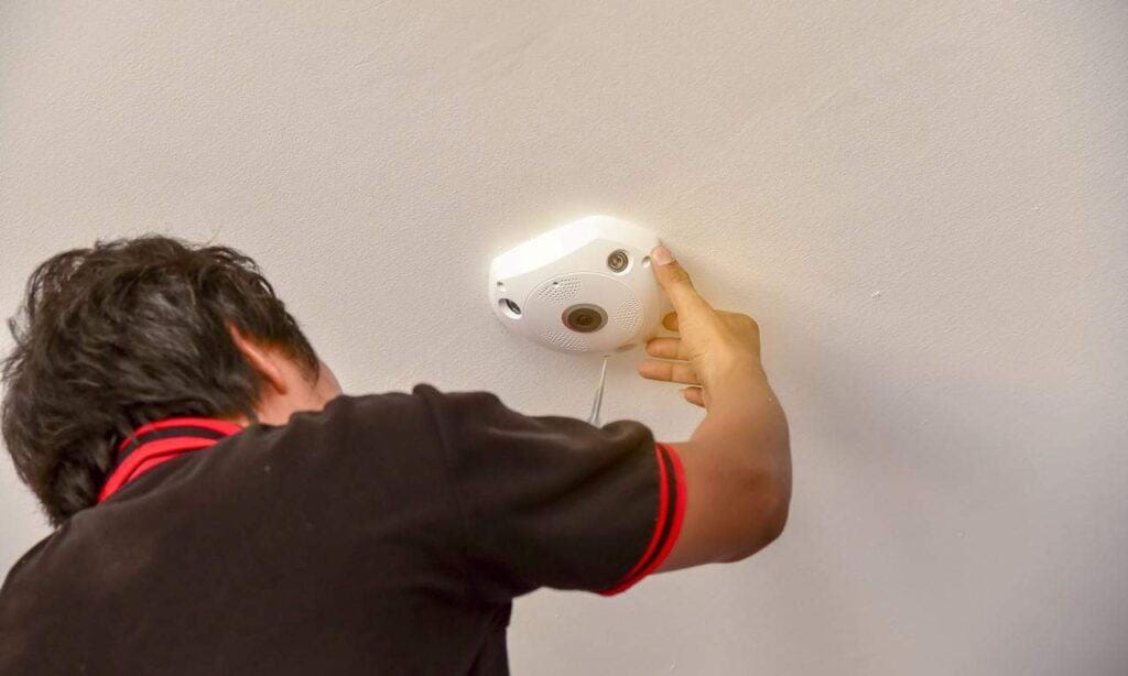 Ceiling smoke detector installation for optimum safety and fire monitoring solutions.
