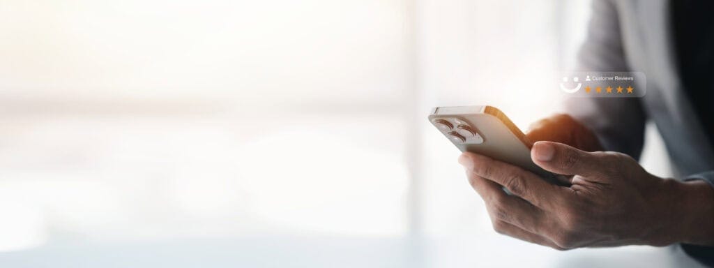 Close-up of person holding a smartphone with customer review overlay, highlighting reliable network solutions.
