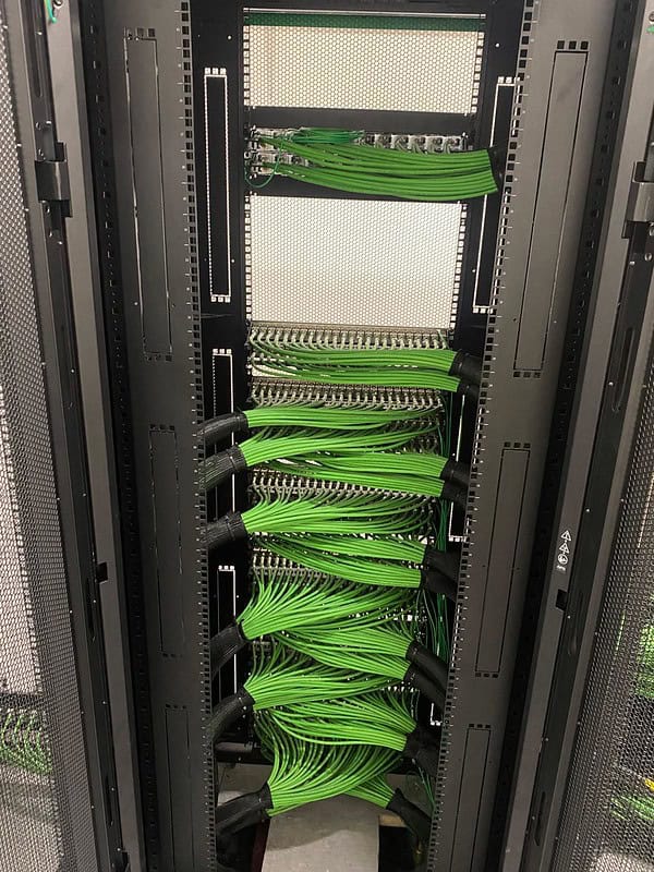 Green network cabling terminated inside the Sumitomo Corporation Europe Limited project cabinet