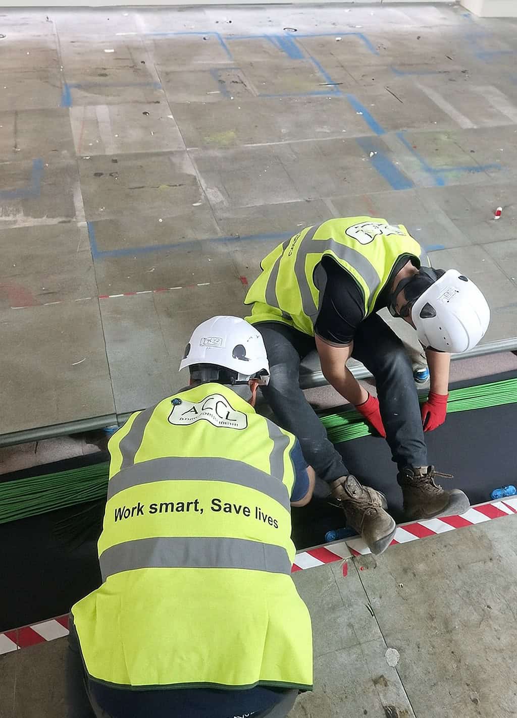 ACCL engineers installing green network cabling beneath the raised floor for Sumitomo Corporation Europe Limited