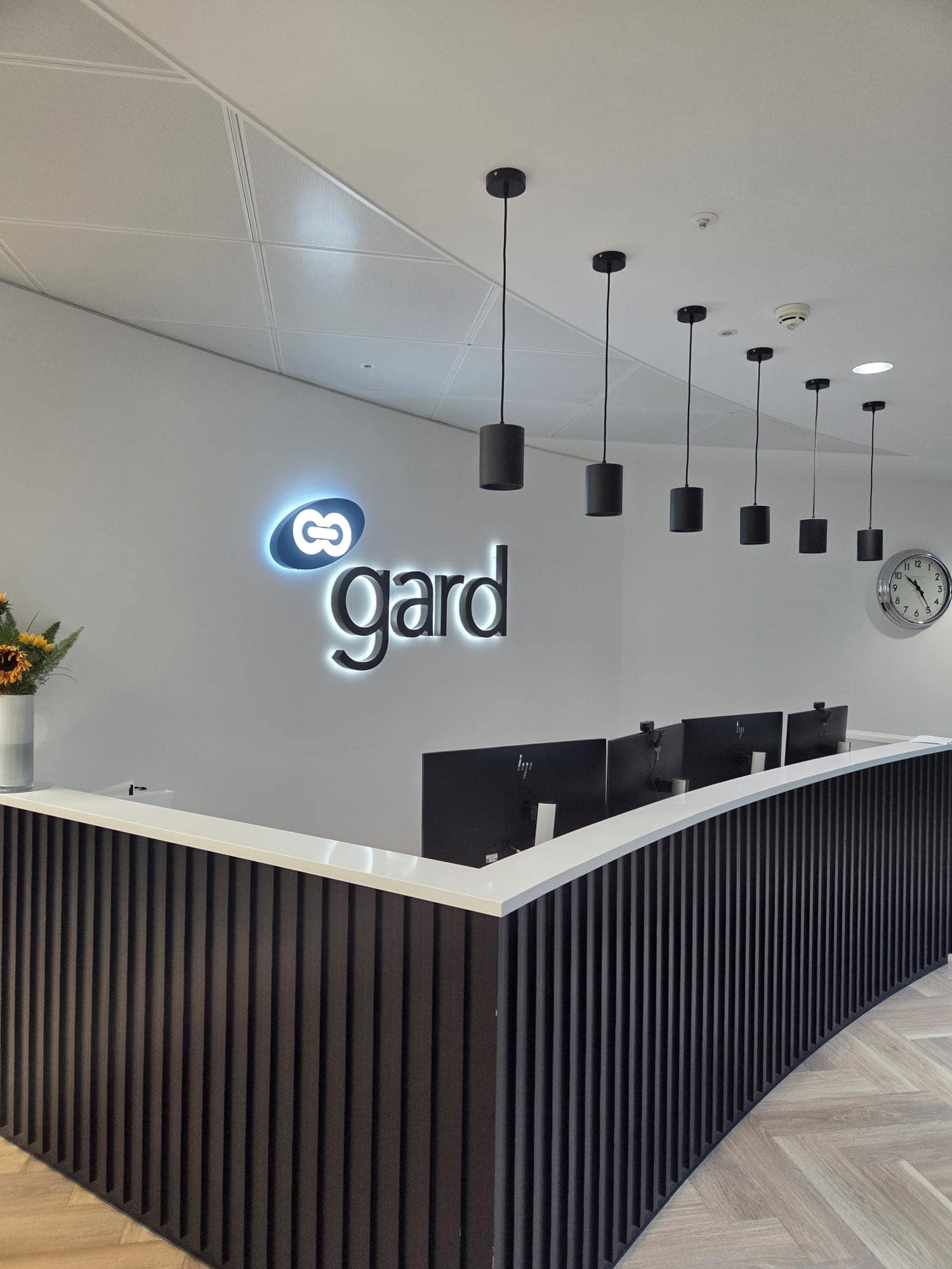 Gard's reception on Level 5 of The Minster Building, City of London, with the illuminated Gard logo