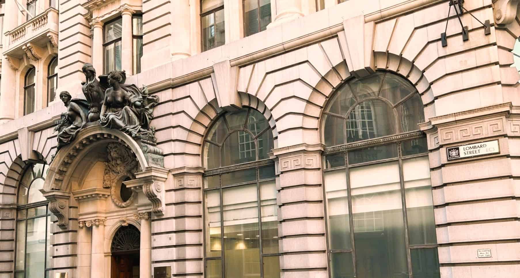 Historic building with large arched windows and ornate entrance.