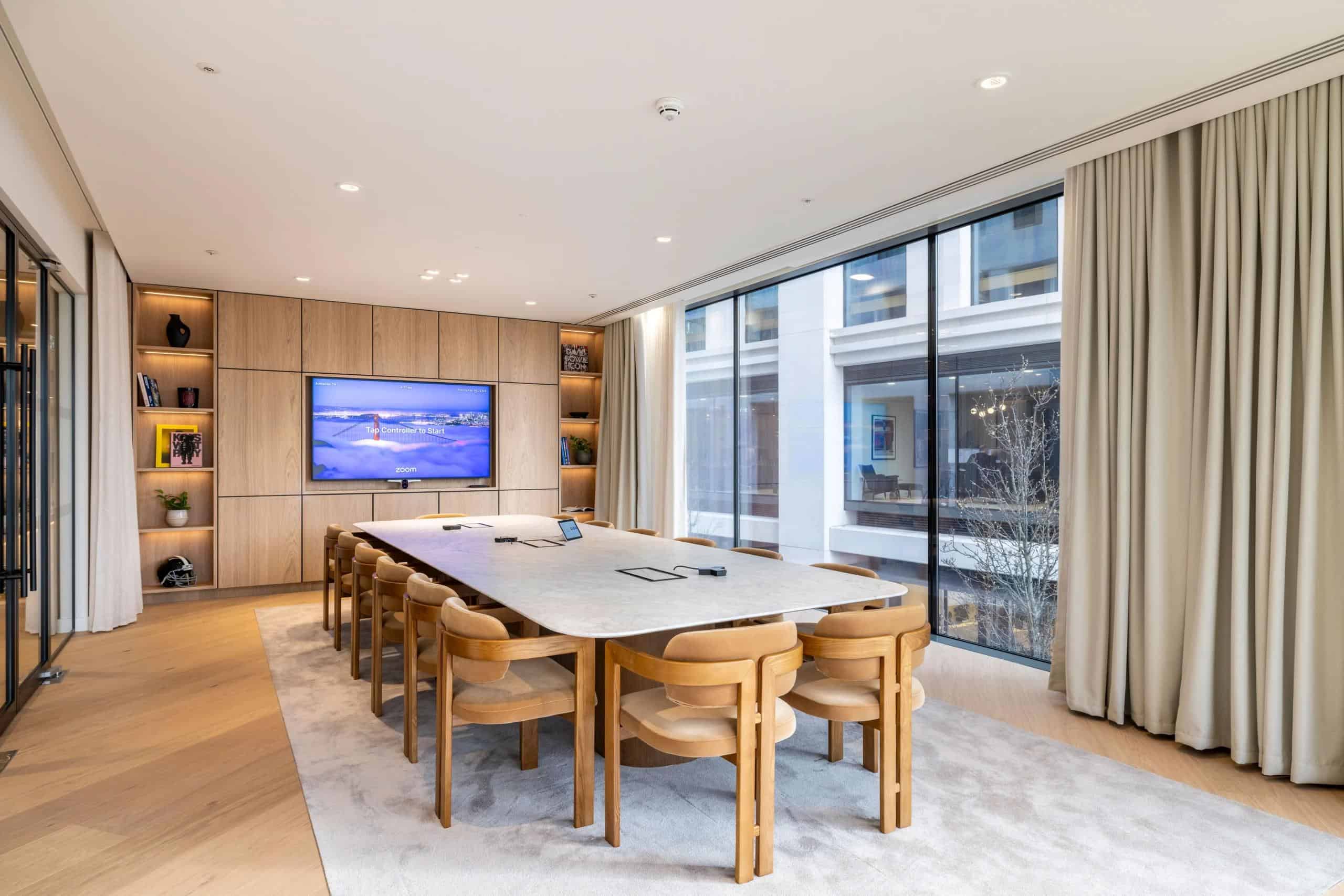 Meeting room with video conferencing screen inside Jimmy Choo's Victoria, London headquarters