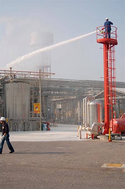 Industrial fire monitor being tested, illustrating the type of fire safety equipment protected by fire-survival network infrastructure