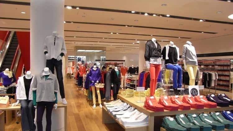 Interior sales floor and escalator area of UNIQLO's Oxford Street flagship store, London